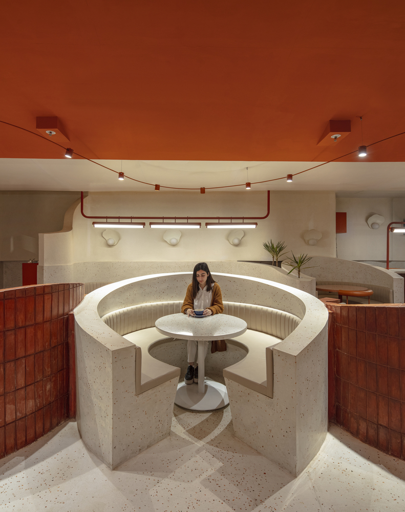 a picture of a woman sitting in the cafe